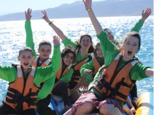 group of teenagers with cancer having water jet ski in Eilat