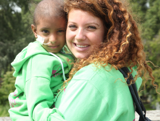 cancer sick girl with a volunteer at zichron menachem summer camp